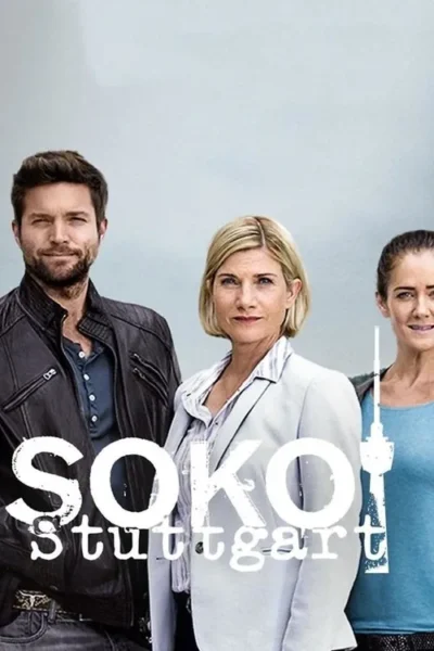 Um homem barbudo de jaqueta escura e duas mulheres, uma de blazer claro, posam à frente de um fundo urbano suave e céu cinzento. Clima profissional.