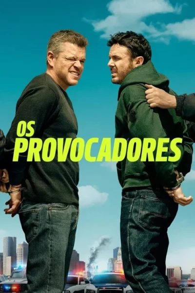 Dois homens algemados, um irritado e outro apreensivo, em frente a uma cidade com viaturas policiais e fumaça sob céu azul.