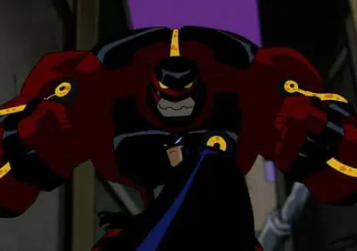 Uma figura animada massiva em armadura vermelha e preta com detalhes dourados. Um herói de capa escura está parcialmente atrás, em beco escuro.