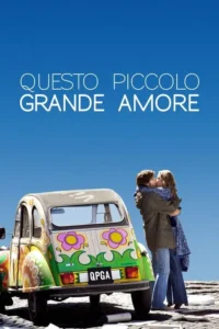 Um casal se beija ao lado de um carro hippie colorido,sob um céu azul claro. Clima romântico e livre.