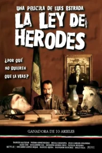Homem sério de bigode em terno,sentado à mesa com cabeças de porco e burro com chapéu. Bandeira mexicana atrás. Sátira política.