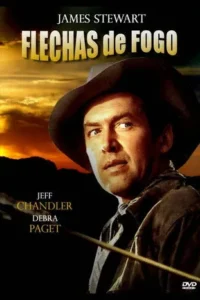 Homem de chapéu de cowboy,rosto focado,com flecha no primeiro plano,contra pôr do sol alaranjado e montanhas escuras.