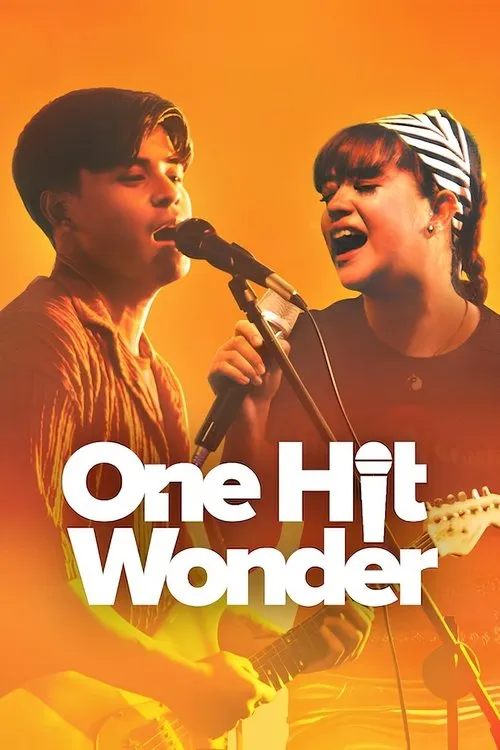 One Hit Wonder 1 Dois jovens músicos,um rapaz e uma moça,cantam com microfones e guitarras num palco vibrante,em tons de laranja.
