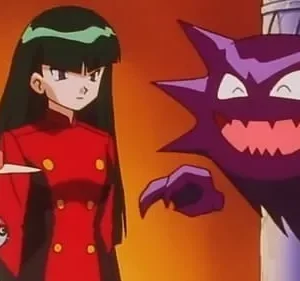 Mulheres sérias, uma de casaco vermelho e outra de chapéu branco, observam uma criatura roxa sorridente emergir. Fundo quente e laranja.