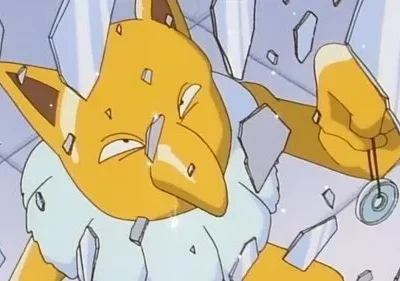 Criatura amarela de nariz grande, com pêndulo, rodeada por cacos de vidro flutuantes. Parece quebrando algo.