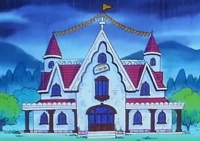 Casa animada branca com telhado vermelho e torres, decorada com banners, em dia chuvoso. Montanhas escuras ao fundo.