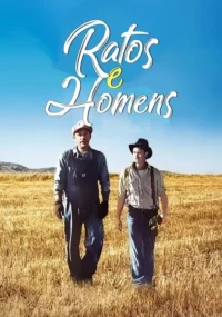 Dois homens com roupas de época, um de macacão e boné, outro de chapéu, num campo de grama seca sob céu azul.