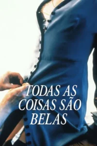 Close-up:mãos abotoam um vestido azul-marinho. A cena é íntima,focando no gesto e na vestimenta escura.