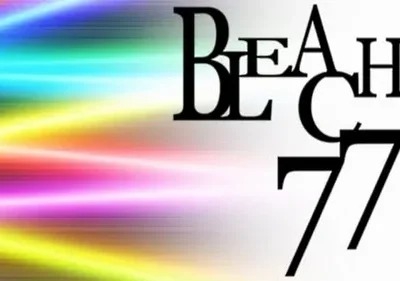 Pôster abstrato: fundo com raios de luz em arco-íris vibrante. Letras pretas grandes e empilhadas dominam a parte direita.