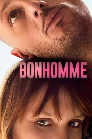 Close-up de um homem barbudo e uma mulher com franja, rostos muito próximos. Ele olha para cima, ela para a frente. Atmosfera íntima.