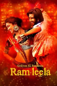 Um casal em trajes indianos vibrantes dança apaixonadamente num fundo vermelho intenso. A mulher sorri,o homem grita com energia.
