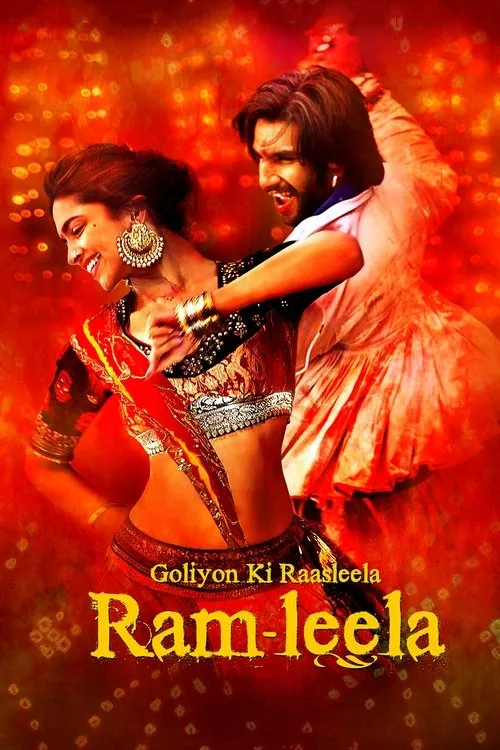 Um casal em trajes indianos vibrantes dança apaixonadamente num fundo vermelho intenso. A mulher sorri,o homem grita com energia.