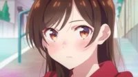 Anime girl de cabelo castanho, olhos âmbar e bochechas coradas, com expressão suave e ligeiramente tímida. Fundo urbano desfocado.