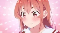 Anime girl de cabelos rosa, olhos grandes e bochechas coradas, com expressão envergonhada. Fundo rosa e pontos.