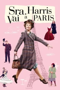 Mulher madura sorridente em casaco xadrez e chapéu floral salta sobre fundo rosa com Torre Eiffel e figuras de moda. Clima vibrante de viagem.