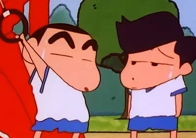 Dois garotos de anime em uniforme esportivo. Um se esforça com um aro, o outro suado e com expressão de desânimo. Cenário verde.