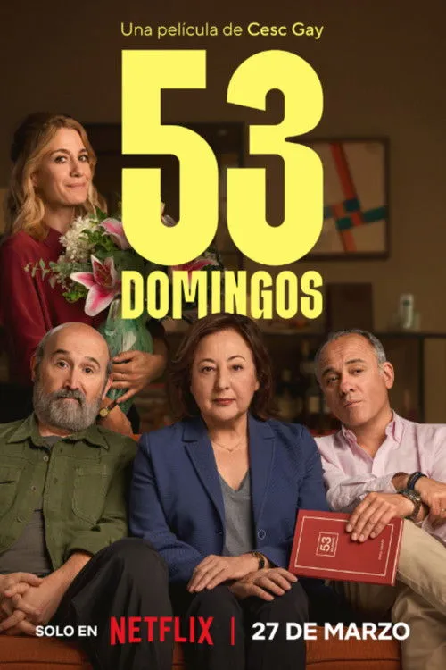 Uma mulher sorridente com flores e três adultos (dois homens,uma mulher) sentados com expressões variadas,em sala.