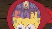 Um personagem amarelo com capuz vermelho. Um pequeno ser verde está dentro de sua cabeça, onde letras coloridas soletram FUN. Ambiente surreal.