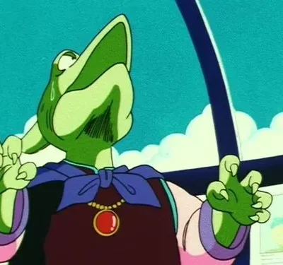 Uma criatura alienígena verde de túnica roxa e pingente vermelho, com garras, olha para cima angustiada, em interior futurista.