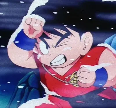 Jovem guerreiro anime de cabelo espetado, com roupa vermelha e azul, cerra os dentes em meio à neve, punho erguido em pose de ataque.