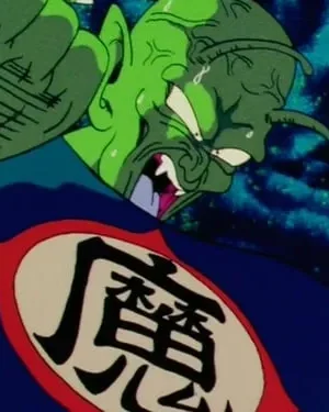 Personagem alienígena verde em angústia, com lágrimas e punho levantado. Veste túnica azul com símbolo oriental no peito. Fundo noturno nebuloso.
