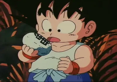 Jovem de anime, cabelo espetado, olhos grandes, segurando objeto. Parece surpreso em cenário escuro avermelhado.