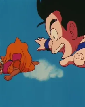 Dois personagens de anime voam no céu azul. Um menino sorridente em primeiro plano, um homem com turbante e expressão zangada mais atrás.