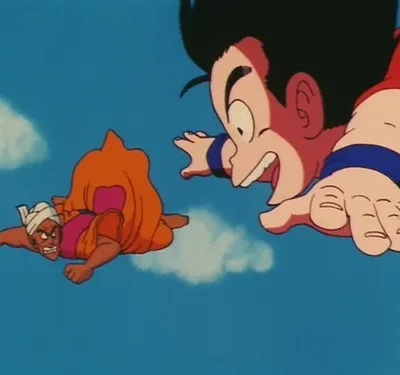 Dois personagens de anime voam no céu azul. Um menino sorridente em primeiro plano, um homem com turbante e expressão zangada mais atrás.