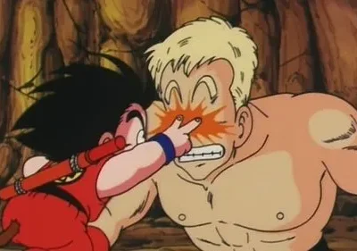 Menino de cabelo espetado e rabo cutuca o olho de um homem musculoso loiro, que reage com dor. Fundo de caverna/pedras.