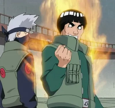 Dois homens com coletes verdes em uma arena. Um com máscara e cabelo prateado; outro com aura flamejante, punho cerrado e expressão entusiasmada.