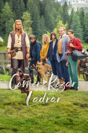 Grupo de seis pessoas, incluindo um homem de cabelo comprido e vestuário rústico, e três cães, em um cenário montanhoso e florestal.