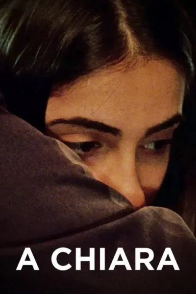 Close-up de mulher jovem com cabelo escuro, rosto parcialmente coberto por tecido. Olhos para baixo, criando um clima íntimo e pensativo.