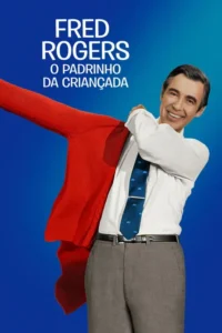 Um homem sorridente de camisa branca e gravata,vestindo um cardigã vermelho sobre um fundo azul brilhante.