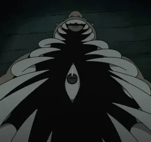 De Fullmetal Alchemist, um monstro musculoso e sorridente. Um olho vertical se destaca de uma massa peitoral escura com pontas afiadas. Fundo escuro.