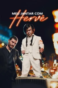 Dois homens à noite. Um de terno branco sobre um carro,segurando garrafa. Outro de terno escuro e barba ao lado. Luzes da cidade.