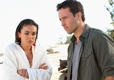 Em Hawaii Five-0, um homem e uma mulher de roupão, ambos com expressão séria, num cenário de praia ensolarada. Clima tenso.